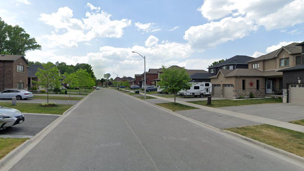 Completed east Bishop Drive streetscape with homes, sidewalks, curbs, and driveway connections