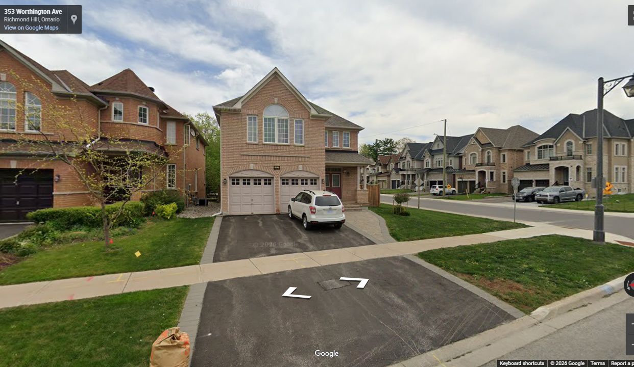 Completed Bloomington Forest subdivision street with curbs, sidewalks, driveways, and homes