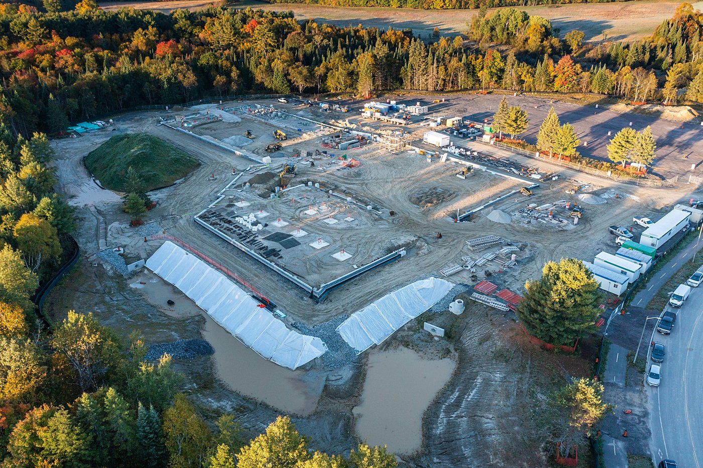 Aerial drone view of construction during fall with SWM pond