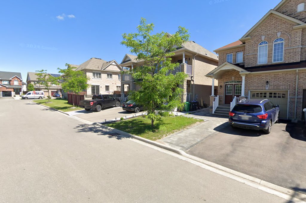 Cachet Estates – Brick homes and mature trees along Micarta Avenue looking north