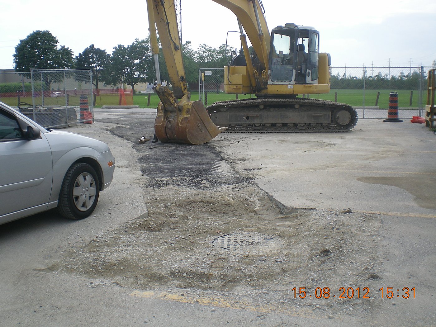 Excavator on campus parking lot construction at Centennial College