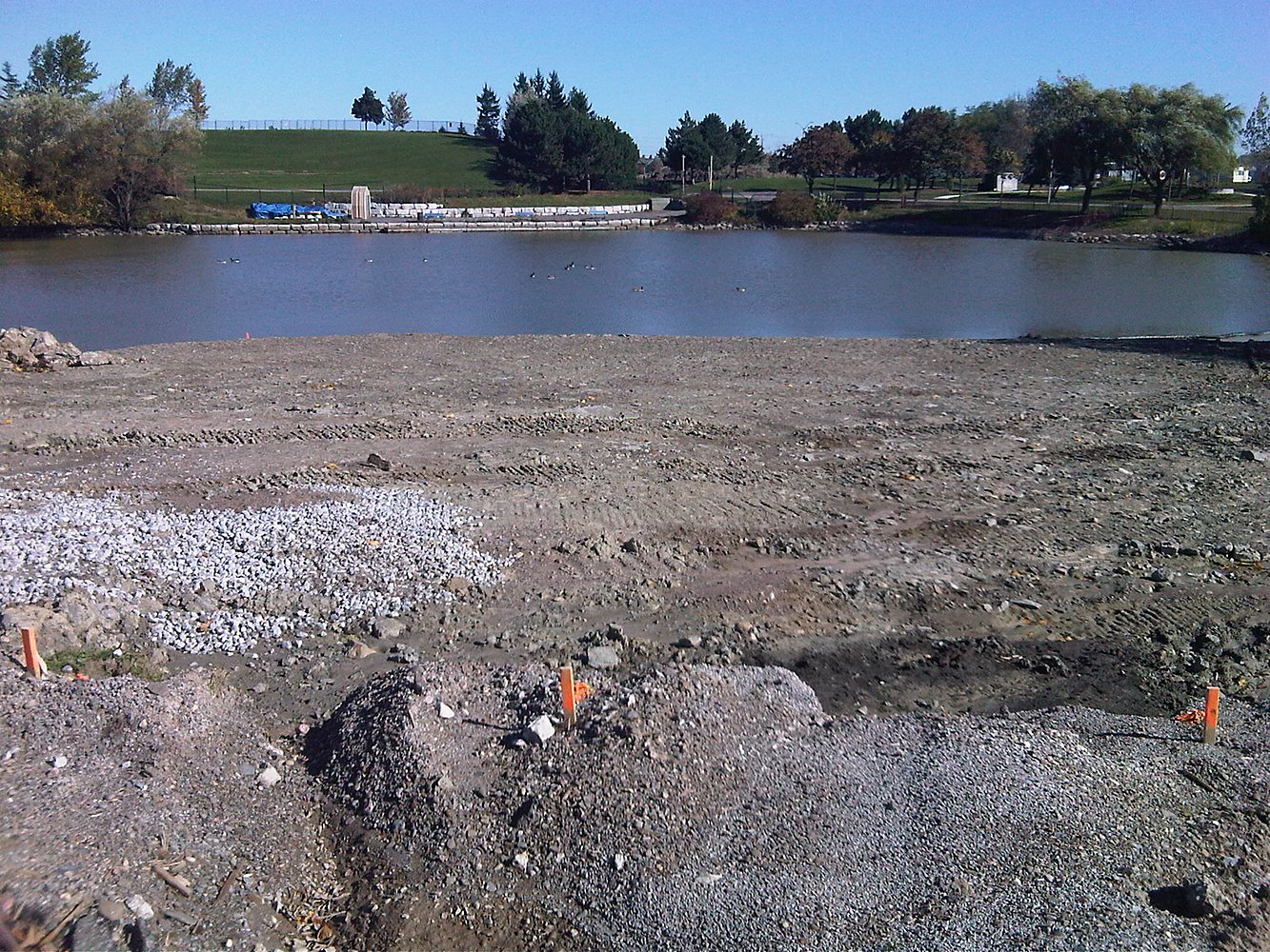 Park pond with riprap shoreline at Chinguacousy Park redevelopment