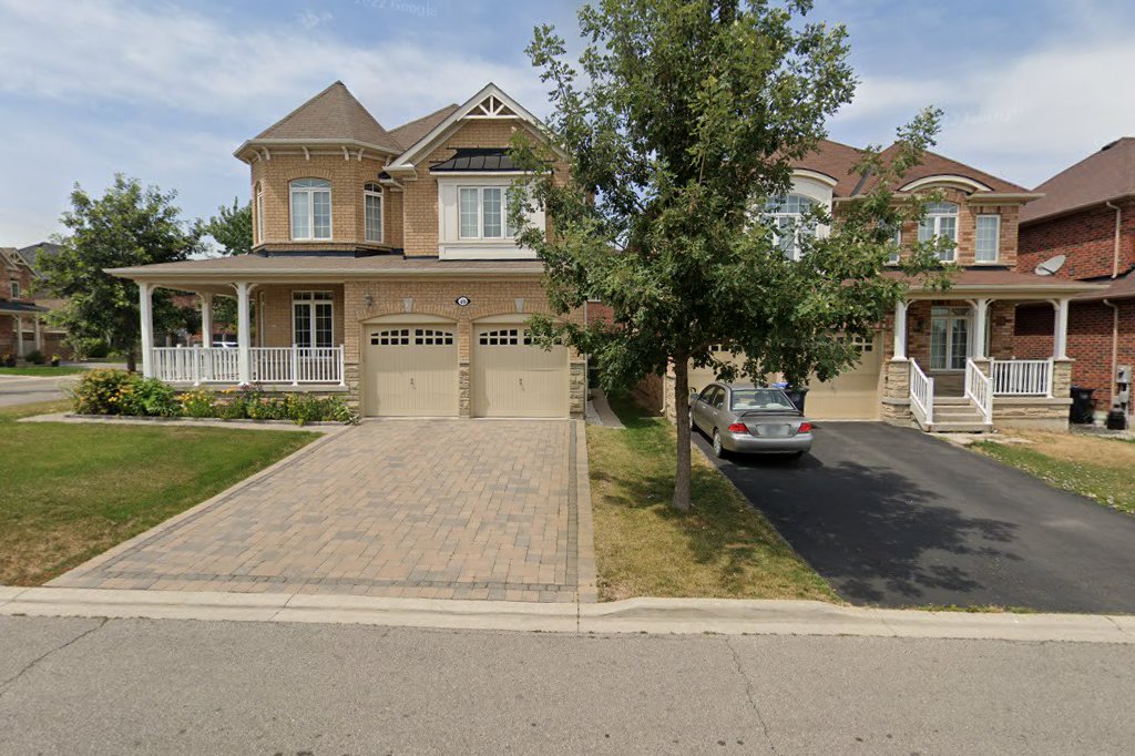 Maybeck Drive – Brick home with paver driveway, mature tree, and front porch in Denford Estates West