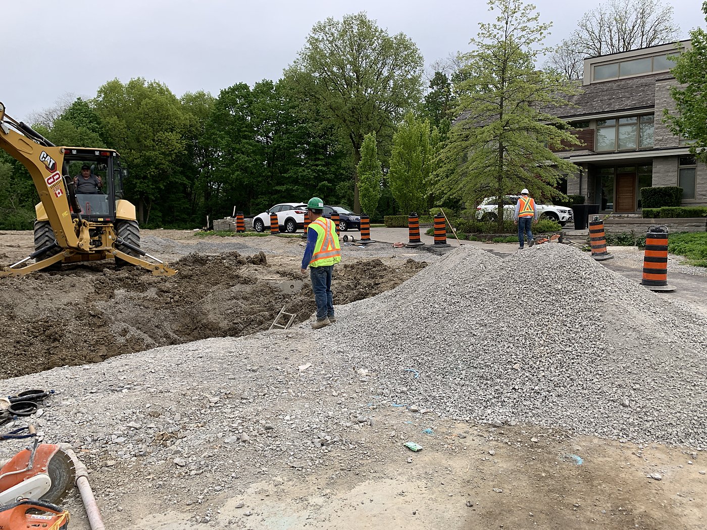 CAT excavator and crew at watermain final connection