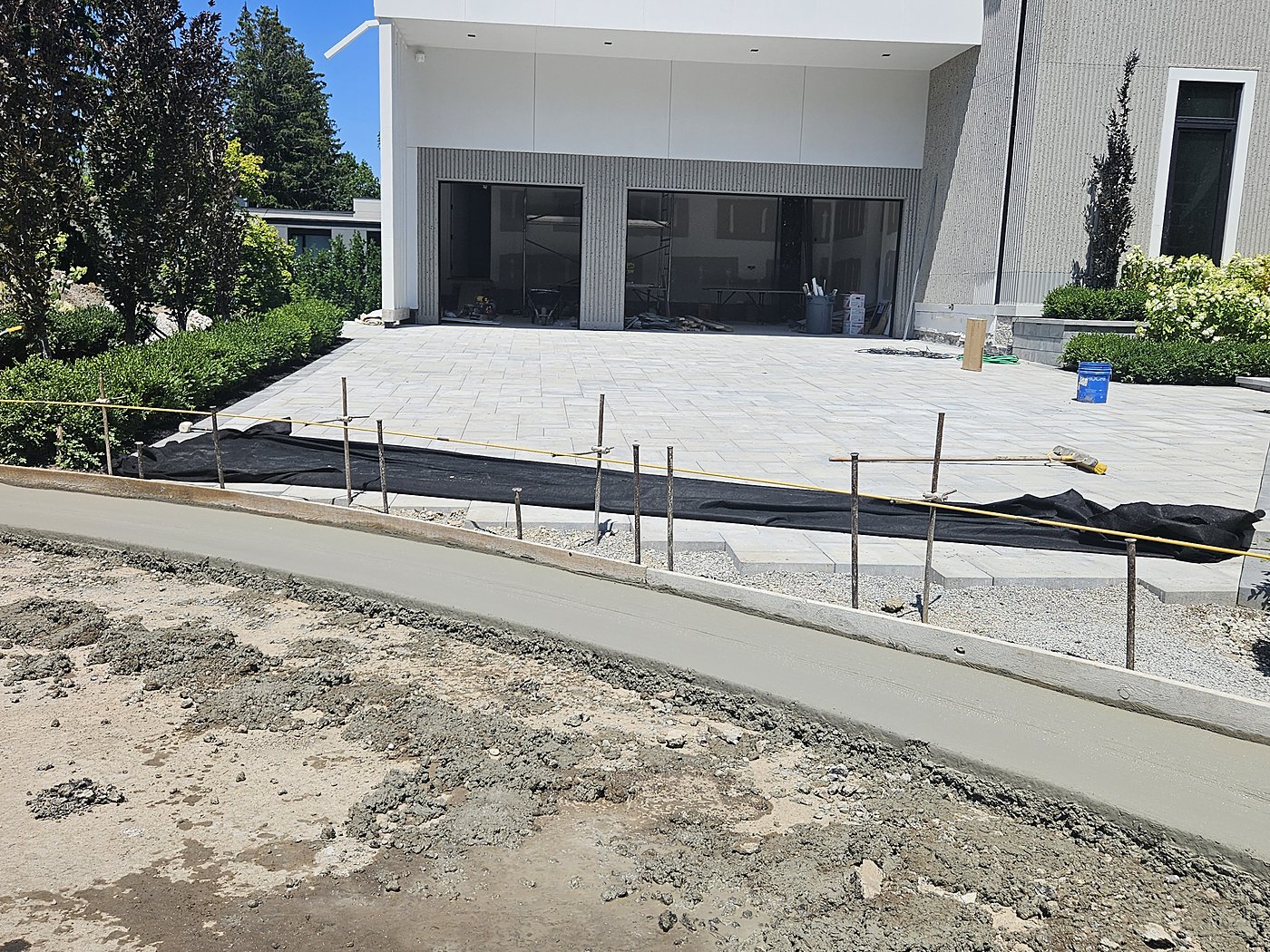 Fresh concrete curb with paver driveway at estate home
