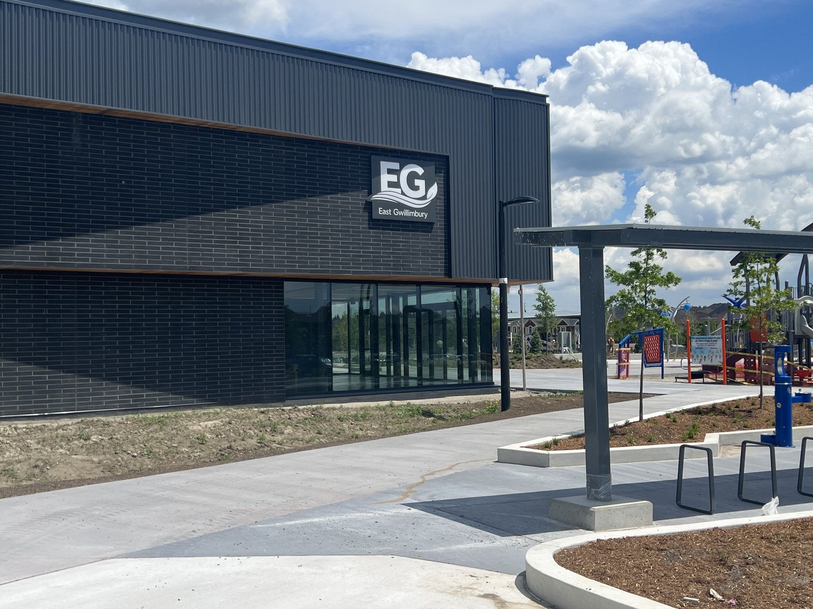 East Gwillimbury Health and Active Living Plaza – glazed entrance corner with the playground beyond