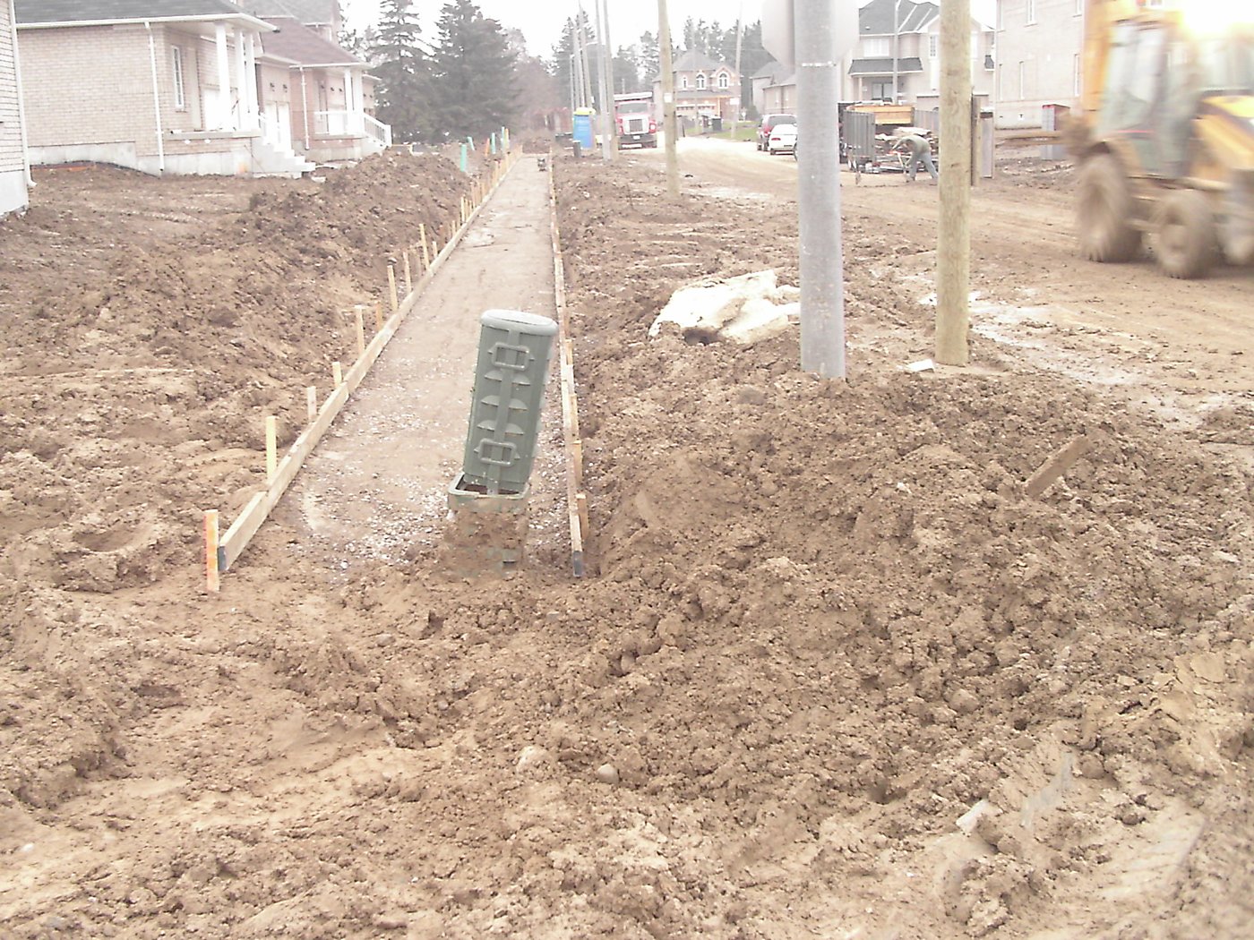 Sidewalk grading with loader at Hamptons Subdivision