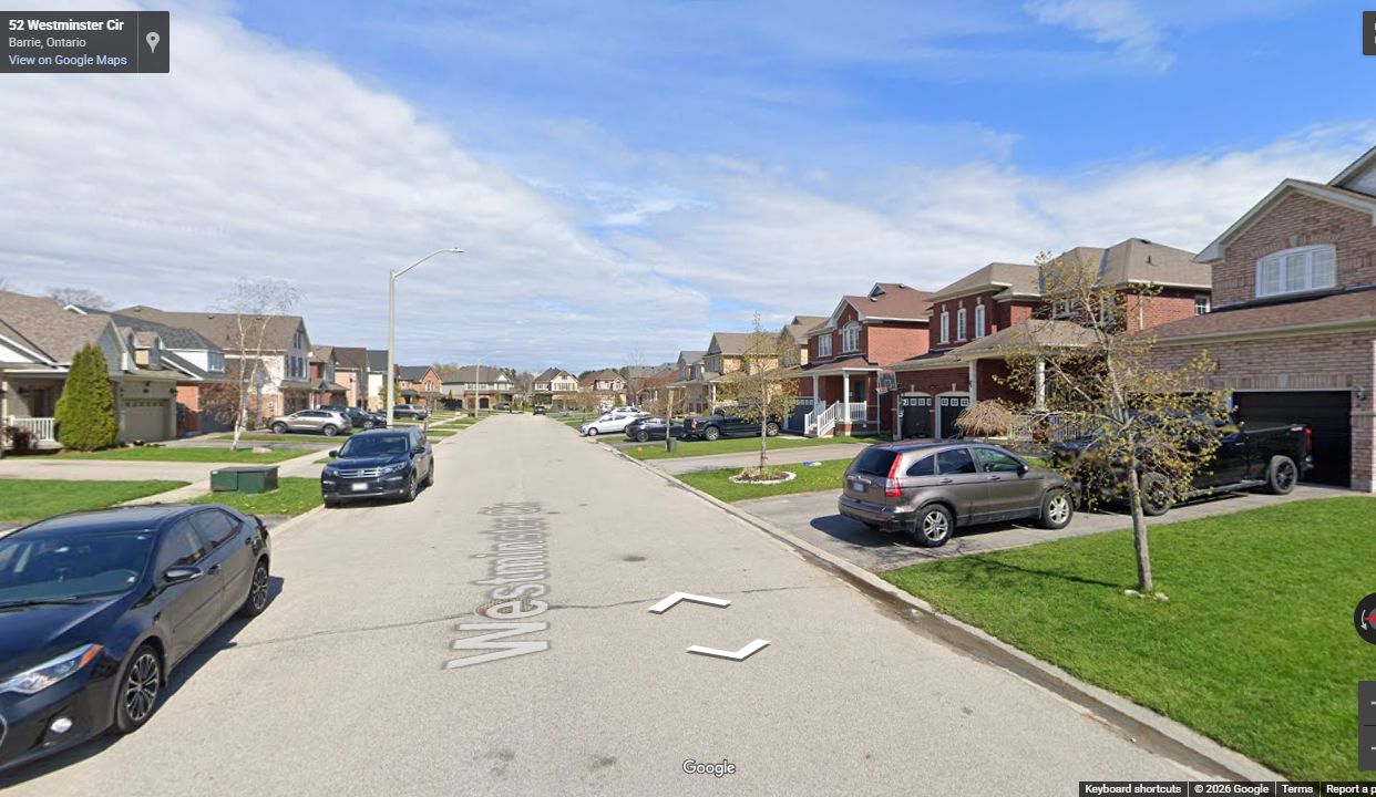 Completed Hamptons subdivision street with curbs, sidewalks, driveways, landscaping, and finished homes
