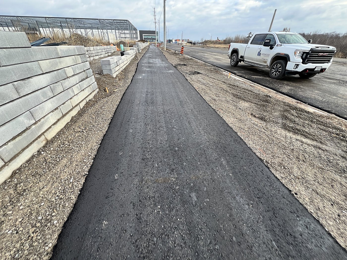 Retaining wall and roadway with white inspection truck