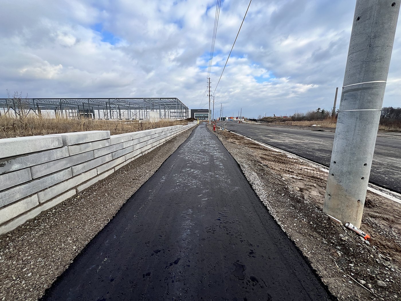Road extension with retaining wall and building frame