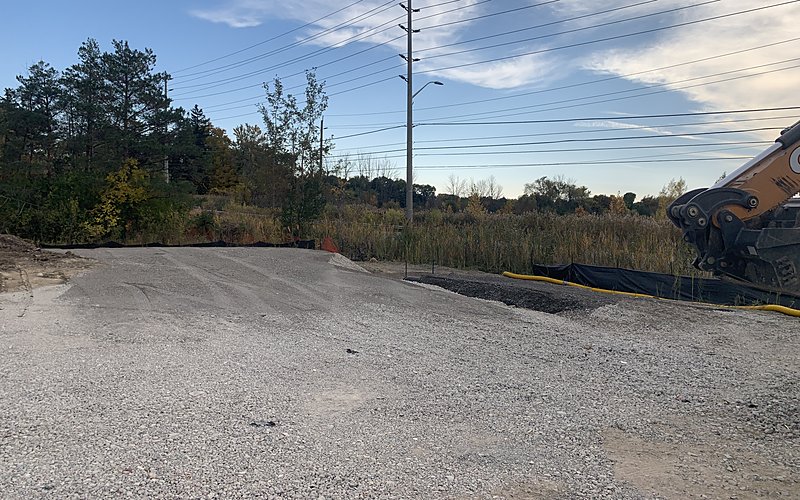 Site reconnaissance with gravel road and excavator