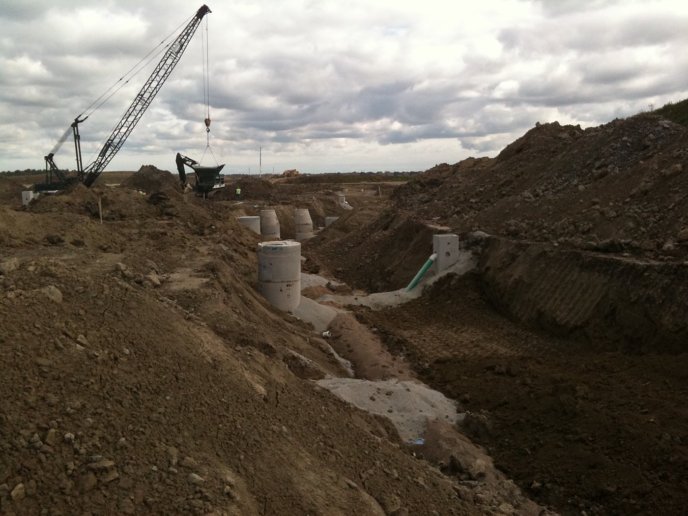 Storm sewer installation with crane and concrete manholes at Lyngate East