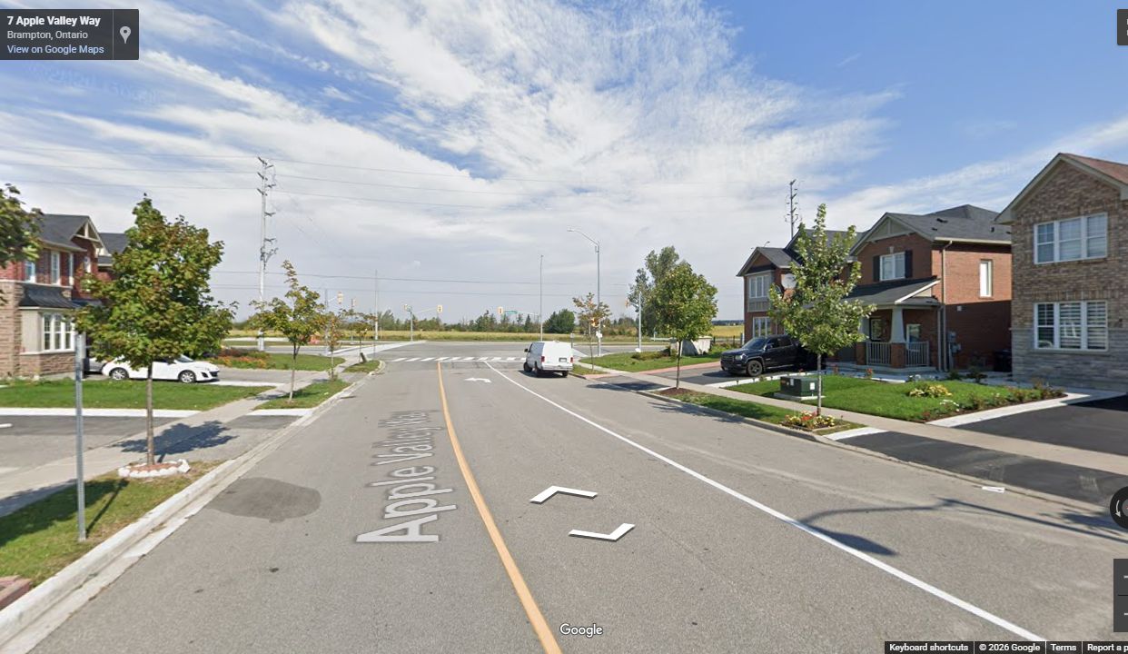 Completed Lyngate East subdivision street with curbs, sidewalks, driveways, and finished homes