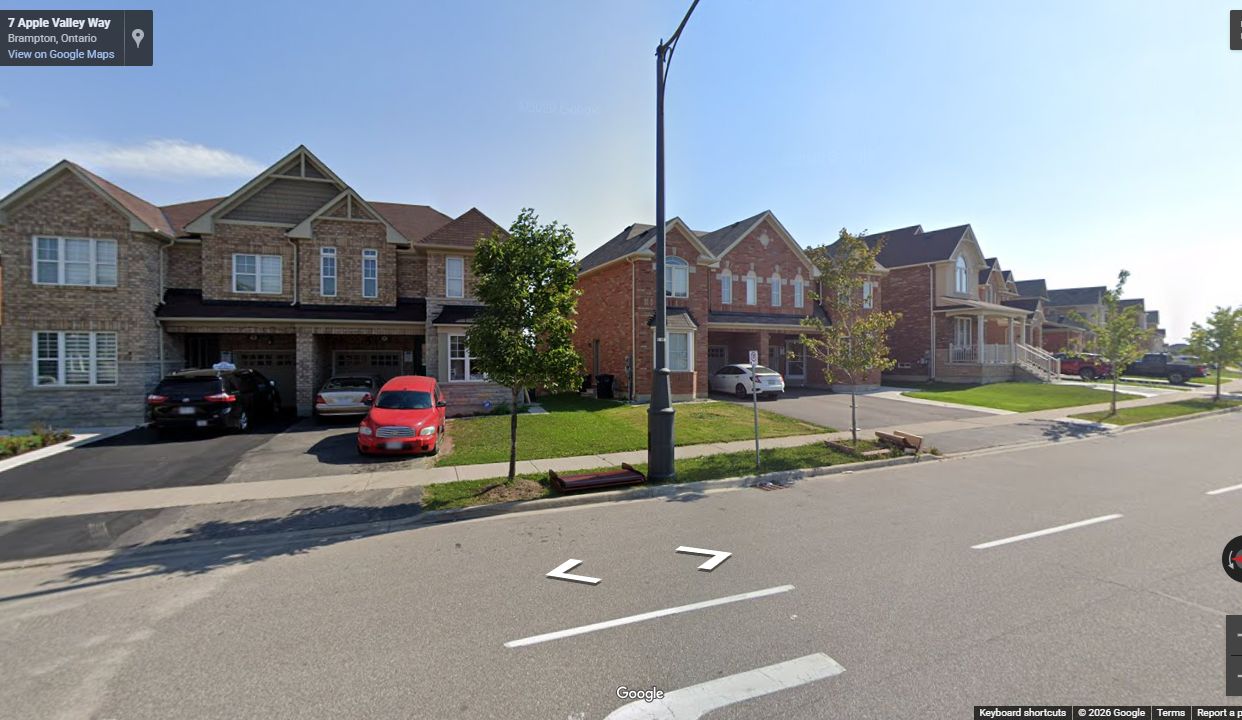 Finished Lyngate East right-of-way with curb, sidewalk, landscaped boulevard, and homes