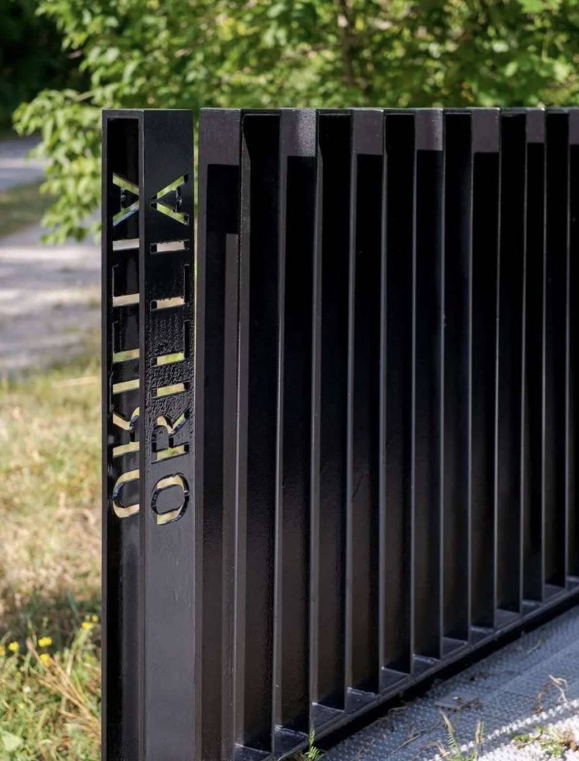 Orillia Recreation and Aquatic Centre – Detail of the bridge railing with the word ORILLIA cut through the black steel end post