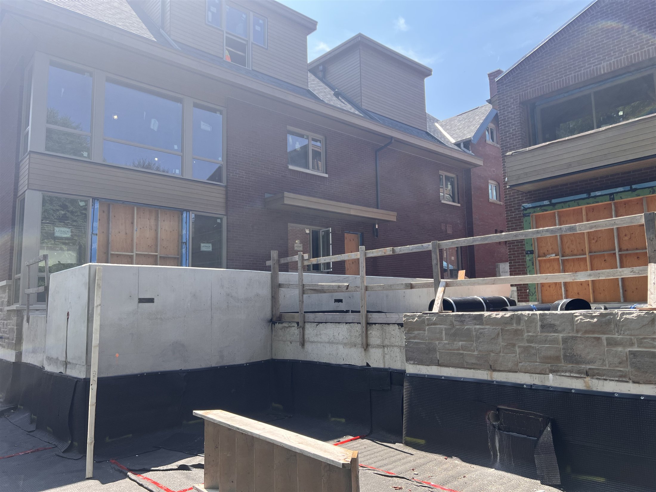Foundation waterproofing, concrete walls, and brick residential buildings at Sherbourne and Rosedale