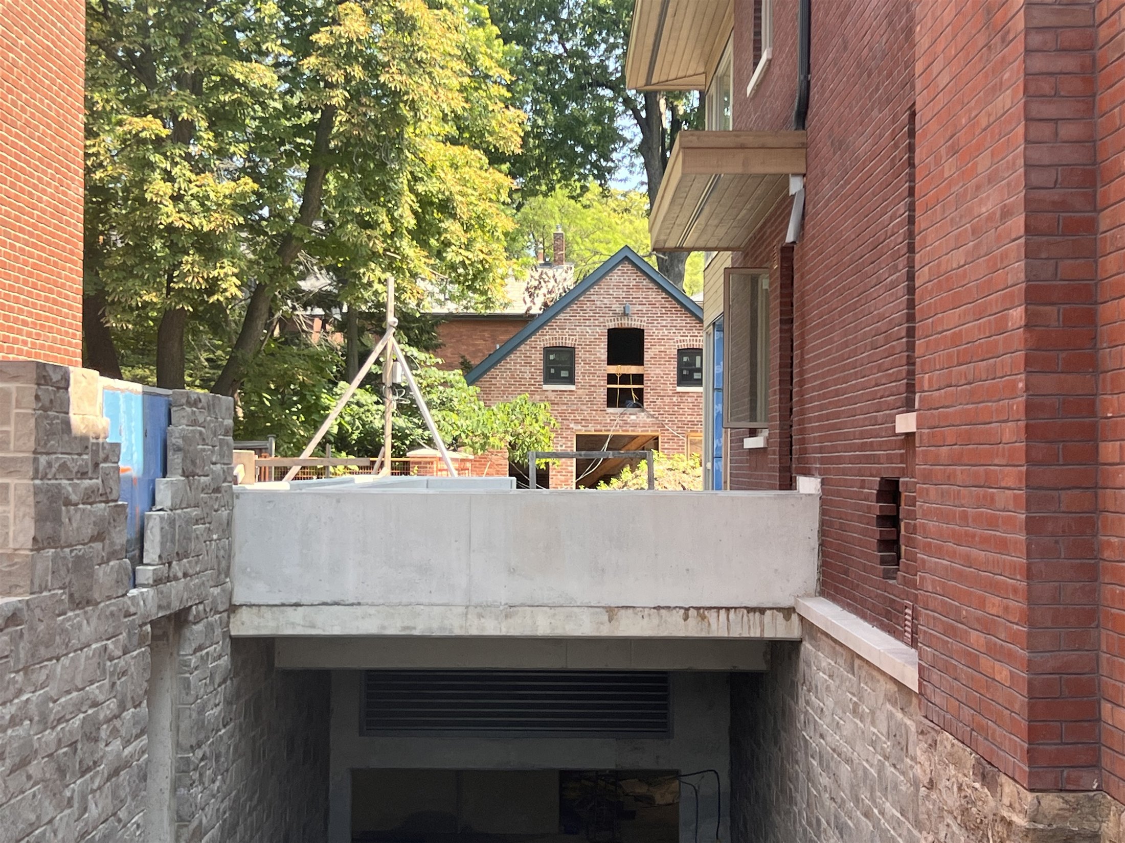 Heritage masonry buildings framing the underground access at Sherbourne and Rosedale