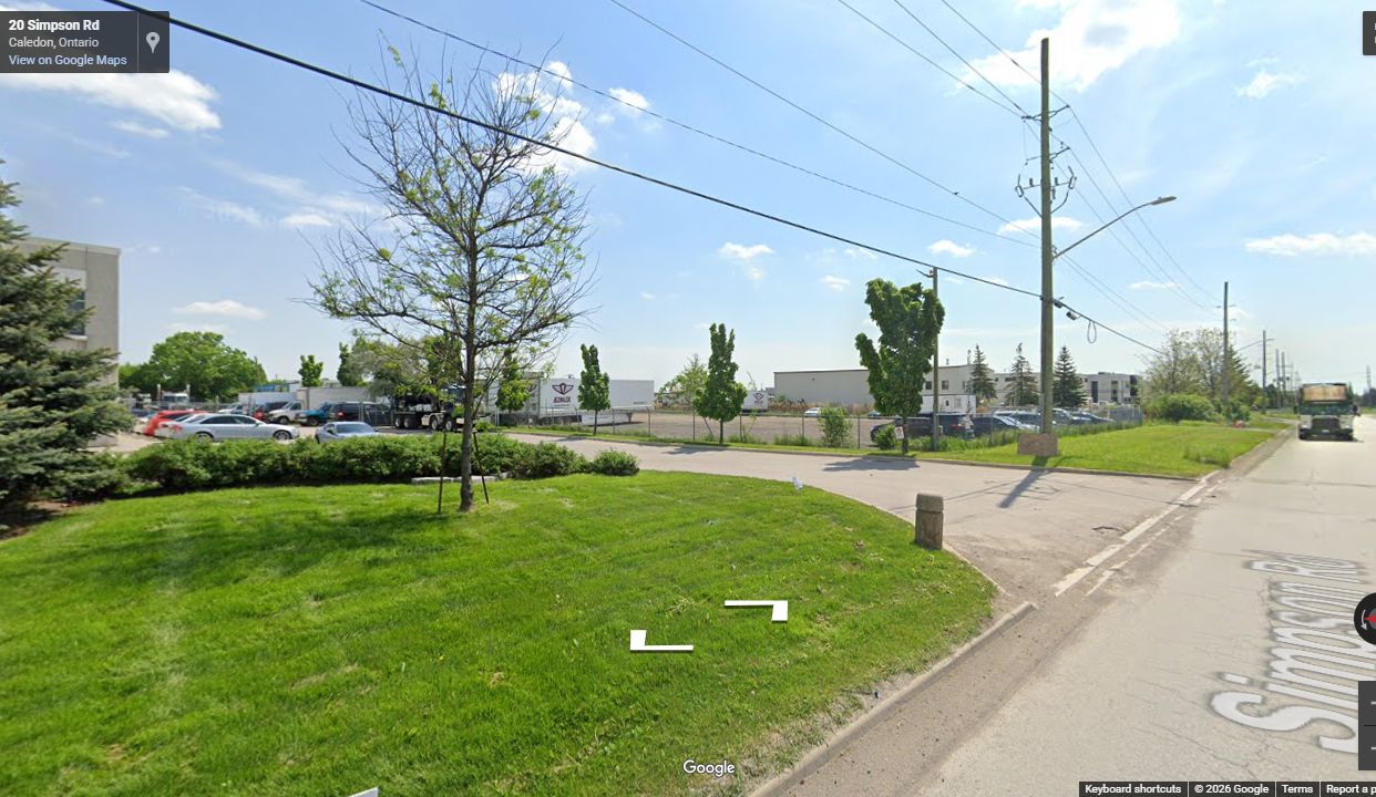 Landscaped industrial access, curb, and finished roadway near Wheeler Drive