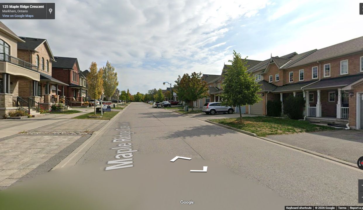 Completed residential right-of-way with curbs, sidewalks, driveways, and boulevard trees